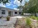 Backyard with gravel landscaping, patio and views of mature landscaping and fencing at 1607 New Bedford Dr, Sun City Center, FL 33573