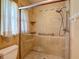 Bathroom featuring a tiled walk-in shower, shower head and window for natural light at 1607 New Bedford Dr, Sun City Center, FL 33573