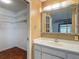 Bathroom with a walk-in closet and an expansive mirror above the sink at 1607 New Bedford Dr, Sun City Center, FL 33573