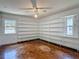 Bedroom with beautiful wood floors and built in shelving on three sides at 1607 New Bedford Dr, Sun City Center, FL 33573
