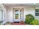 Close-up of the front door showcasing a decorative glass window and well-maintained exterior, creating an inviting entrance at 1607 New Bedford Dr, Sun City Center, FL 33573