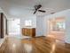 Open-concept living area with hardwood floors, a built-in cabinet, and a view into the adjacent dining room at 1607 New Bedford Dr, Sun City Center, FL 33573
