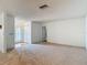 Spacious living room with carpeted flooring, a large window, and ample space for furniture arrangement, creating a cozy ambiance at 1607 New Bedford Dr, Sun City Center, FL 33573