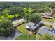 Beautiful aerial view of a home with fenced yard and mature trees in a lush green neighborhood at 17701 Sunrise Dr, Lutz, FL 33549