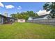 View of the expansive backyard with shed and privacy fence at 17701 Sunrise Dr, Lutz, FL 33549