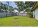 Spacious backyard with a fire pit and a wood privacy fence at 17701 Sunrise Dr, Lutz, FL 33549