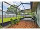 Spacious backyard with partially screened lanai and privacy fence at 17701 Sunrise Dr, Lutz, FL 33549