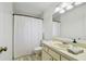 A neutral-toned bathroom featuring a cream sink and vanity with a tub and shower combo at 17701 Sunrise Dr, Lutz, FL 33549