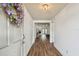 Inviting entryway featuring wood floors and a view of the living room and fireplace, with a hanging wreath at 17701 Sunrise Dr, Lutz, FL 33549