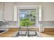 A double basin sink and faucet overlook a gorgeous garden view at 17701 Sunrise Dr, Lutz, FL 33549