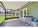Covered and screened patio area with storage and view of backyard at 17701 Sunrise Dr, Lutz, FL 33549