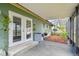 View of the partially screened patio with a grill and small seating area at 17701 Sunrise Dr, Lutz, FL 33549