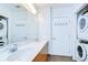 Bathroom featuring double sinks, contemporary fixtures, and convenient in-unit laundry, combining style and functionality at 2001 E 2Nd Ave # 12, Tampa, FL 33605