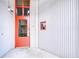 Close-up of a red door with security features and a corrugated metal wall at 2001 E 2Nd Ave # 12, Tampa, FL 33605