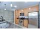 Compact kitchen with wooden cabinets, stainless steel appliances, and granite countertops at 2001 E 2Nd Ave # 12, Tampa, FL 33605