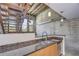 Charming kitchen area featuring granite countertops, wooden accents, and a view of the staircase at 2001 E 2Nd Ave # 12, Tampa, FL 33605