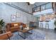 Open-concept living room showcases exposed brick, a modern kitchen, and a cozy seating area with stylish decor at 2001 E 2Nd Ave # 12, Tampa, FL 33605