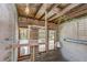 Charming loft area with exposed brick, a cozy nook, and ample natural light streaming through large windows at 2001 E 2Nd Ave # 12, Tampa, FL 33605