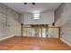 Second floor loft featuring hardwood floors, exposed brick, minimalist decor, and open railing, creating a bright, airy space at 2001 E 2Nd Ave # 12, Tampa, FL 33605