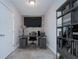 Cozy home office with a rustic desk, shelving, and a wall-mounted TV at 2001 E 2Nd Ave # 12, Tampa, FL 33605