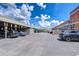 Expansive outdoor parking lot with ample spaces beneath a bright blue sky with a mixture of cars and building aesthetics at 2001 E 2Nd Ave # 12, Tampa, FL 33605