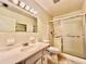 Well lit bathroom with shower and tub combination, updated vanity and classic neutral color scheme at 2341 Haitian Dr # 49, Clearwater, FL 33763