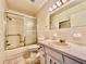 Bathroom featuring shower and tub, classic style vanity with lots of storage, and a neutral color palette at 2341 Haitian Dr # 49, Clearwater, FL 33763