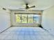 Bedroom with tile flooring, a ceiling fan, natural light, and a large window view at 2341 Haitian Dr # 49, Clearwater, FL 33763