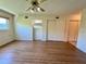 Bedroom features laminate flooring, a ceiling fan, a window, and closet space at 2341 Haitian Dr # 49, Clearwater, FL 33763