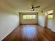 Bright bedroom features laminate flooring, ceiling fan, and windows providing courtyard views at 2341 Haitian Dr # 49, Clearwater, FL 33763