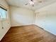A spacious bedroom with ceiling fan, and wood look laminate flooring and a large closet with sliding doors at 2341 Haitian Dr # 49, Clearwater, FL 33763
