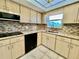 Updated kitchen featuring light wood cabinets, granite countertops, tile backsplash, and modern appliances at 2341 Haitian Dr # 49, Clearwater, FL 33763
