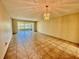 Spacious living room features neutral walls, tile floors, a window, and chandelier at 2341 Haitian Dr # 49, Clearwater, FL 33763