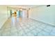 Living room featuring tile flooring, mirrored wall, view into kitchen, and access to rooms at 2341 Haitian Dr # 49, Clearwater, FL 33763