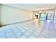 Living room features tile floor, mirrored wall, view into kitchen, and access to the entry at 2341 Haitian Dr # 49, Clearwater, FL 33763