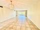 Bright living room features neutral paint, tile floors, large windows, and chandelier at 2341 Haitian Dr # 49, Clearwater, FL 33763