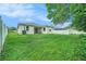 Large, grassy backyard with a well-maintained lawn and a patio area perfect for outdoor living at 247 Winthrop Dr, Spring Hill, FL 34609