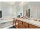 This bathroom features double sinks, soaking tub, a large mirror, and bright lighting at 247 Winthrop Dr, Spring Hill, FL 34609