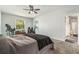 Comfortable bedroom features soft carpet, a ceiling fan, and natural light at 247 Winthrop Dr, Spring Hill, FL 34609
