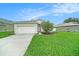 This home has an attached garage with a driveway and curb appeal at 247 Winthrop Dr, Spring Hill, FL 34609