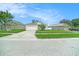 Charming single-story home with a well-manicured lawn and a two-car garage on a sunny day at 247 Winthrop Dr, Spring Hill, FL 34609
