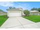 This home has an attached garage with a driveway and curb appeal at 247 Winthrop Dr, Spring Hill, FL 34609