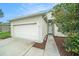 The house offers an attached garage, manicured landscaping, and walkway to the front door at 247 Winthrop Dr, Spring Hill, FL 34609