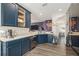 Modern kitchen with stainless steel appliances, wood floors, and an open floor plan at 247 Winthrop Dr, Spring Hill, FL 34609