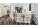 Kitchen with bar seating, modern appliances, and a view to the front entryway at 247 Winthrop Dr, Spring Hill, FL 34609
