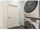 This is a stackable stainless steel washer and dryer for space saving in the laundry room at 247 Winthrop Dr, Spring Hill, FL 34609
