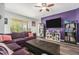Spacious living room with a large sectional, wood floors, and a view of the outdoor patio at 247 Winthrop Dr, Spring Hill, FL 34609