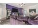 Living room with wood floors, a purple accent wall, and a view of the kitchen area at 247 Winthrop Dr, Spring Hill, FL 34609