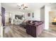 Open-concept living room with wood floors, a comfortable couch, and a view of the kitchen at 247 Winthrop Dr, Spring Hill, FL 34609