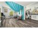 The expansive living room has an open floor plan with modern hardwood floors and stylish furniture at 247 Winthrop Dr, Spring Hill, FL 34609